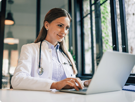 a young female doctor working on her laptop