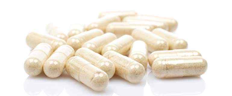  pile of pills sitting on top of a white table