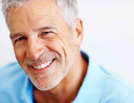 a smilling old man with white hair