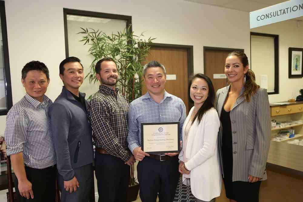 a group of harbor compounding pharmacy ceo and staff standing next to each other