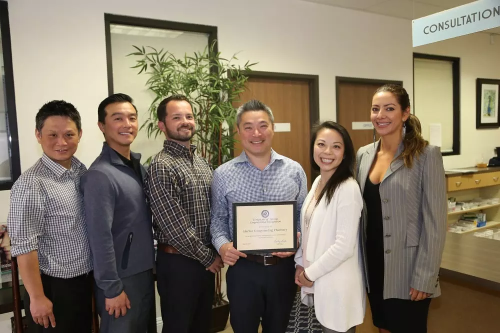 a group of harbor compounding pharmacy ceo and staff standing next to each other