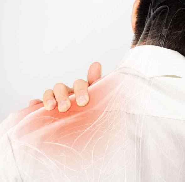 a man pressing back of his shoulder dealing with chronic pain
